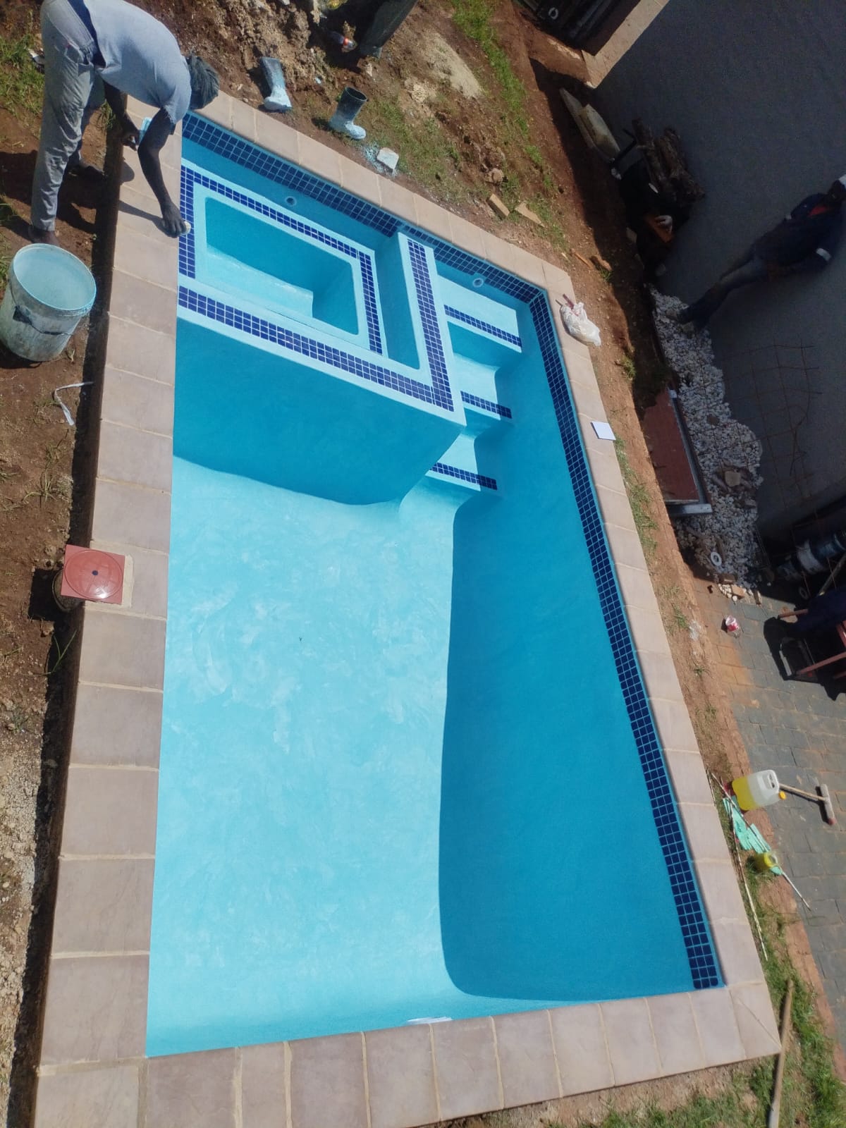 Newly built pool with mosaic step detail
