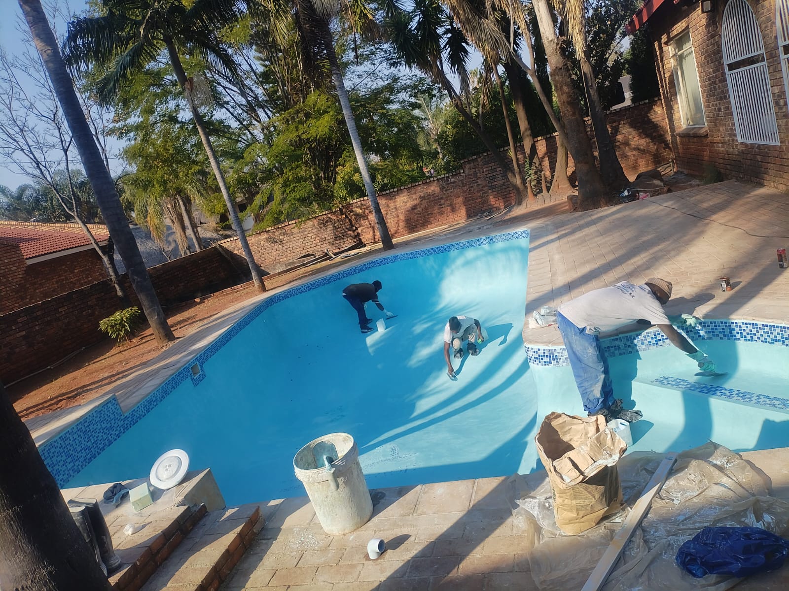 Workers finishing a large pool